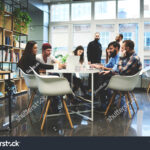 stock-photo-group-of-casually-dressed-businesspeople-discussing-ideas-in-the-office-creative-professionals-511307179