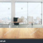 stock-photo-wooden-table-in-sunny-office-with-big-windows-351172964